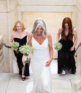  Bride walking up the Town Hall stairs with 2 bridesmaids